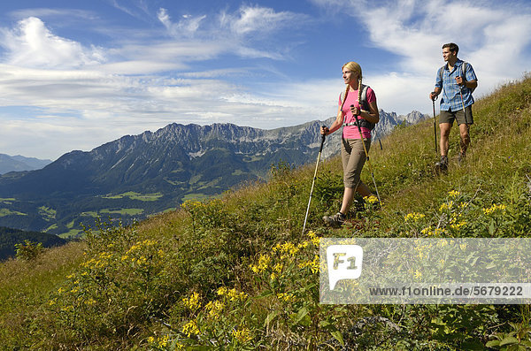 Hikers walking on Hartkaiser mountain  Wilder Kaiser mountain at the back  Tyrol  Austria  Europe