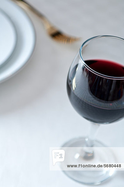 Glass of red wine on table
