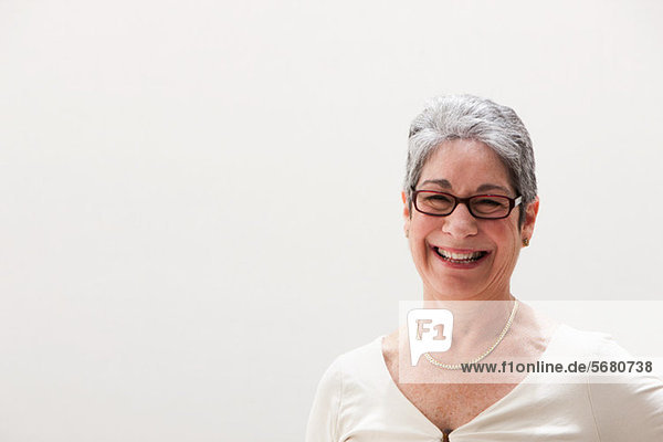 Portrait of mature woman smiling  studio shot