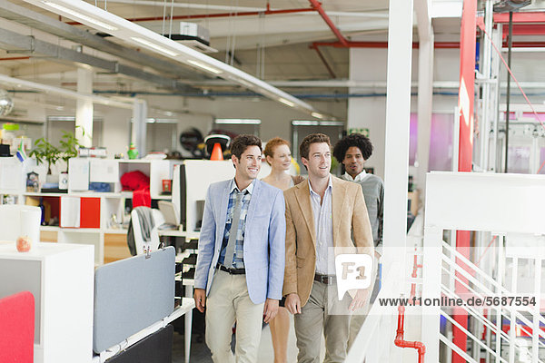 Businessmen walking together in office