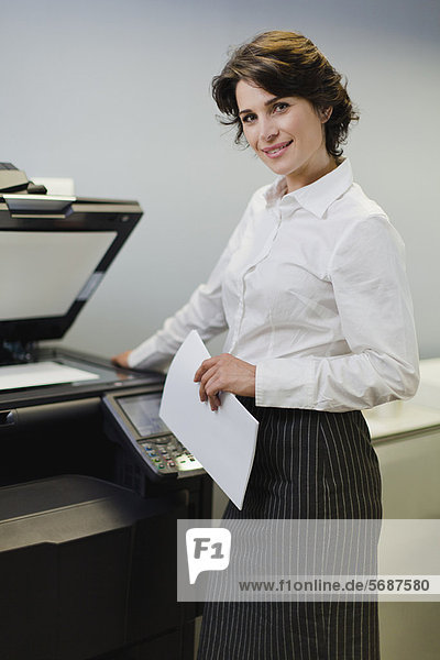 Businesswoman making copies in office