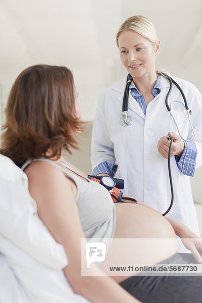 Doctor taking pregnancy blood pressure
