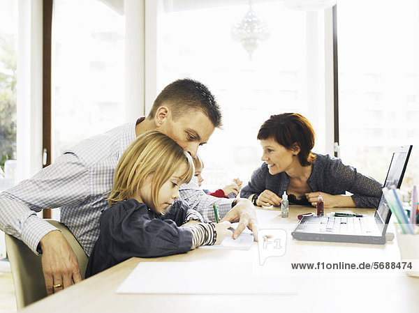Family relaxing at dining room table
