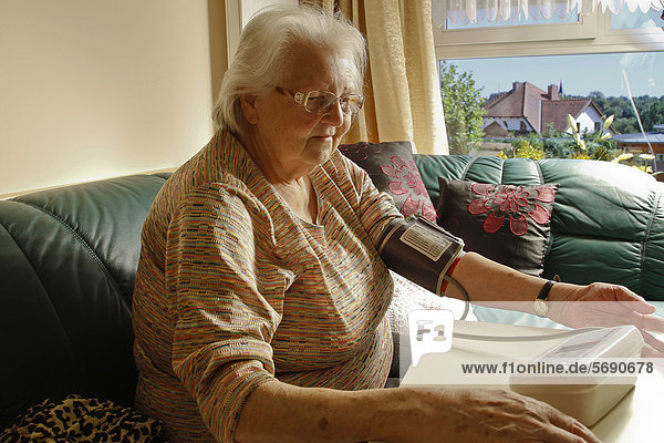 Old woman with a blood pressure gauge