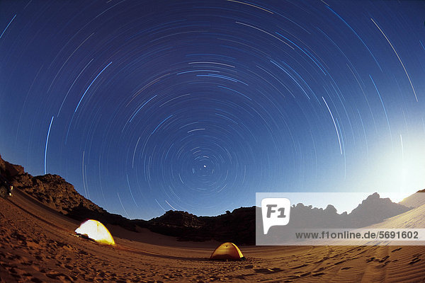 Tents under a starry sky in the Libyan Desert  star trails  Wadi Awis  Acacus Mountains  Libya  Sahara  Africa