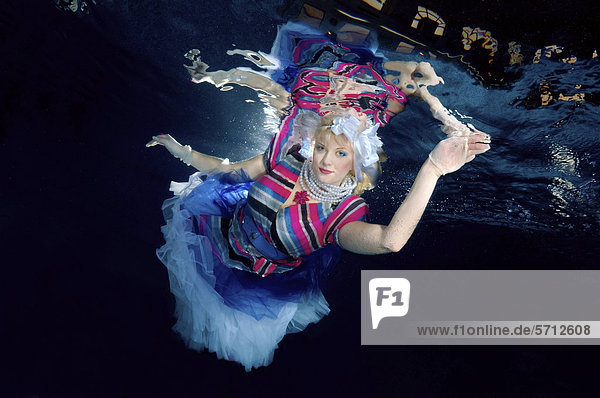 Underwater model presenting fashion in pool  Odessa  Ukraine  Eastern Europe