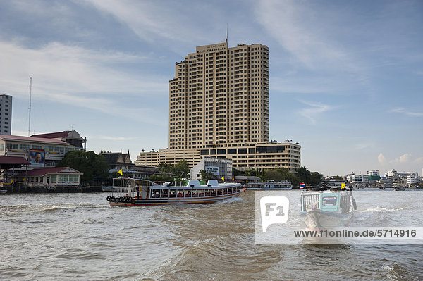 Boats on the Chao Phraya River with views of the city  Bangkok  Thailand  Asia