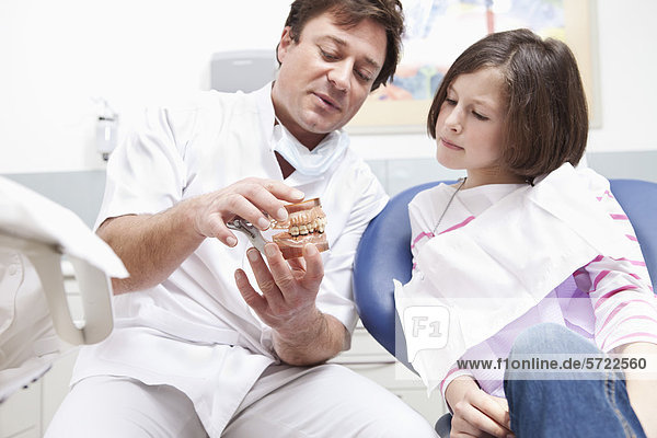 Germany  Bavaria  Patient and doctor looking at dentures