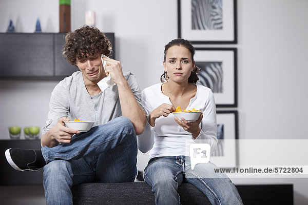 Germany  Bavaria  Young couple watching TV