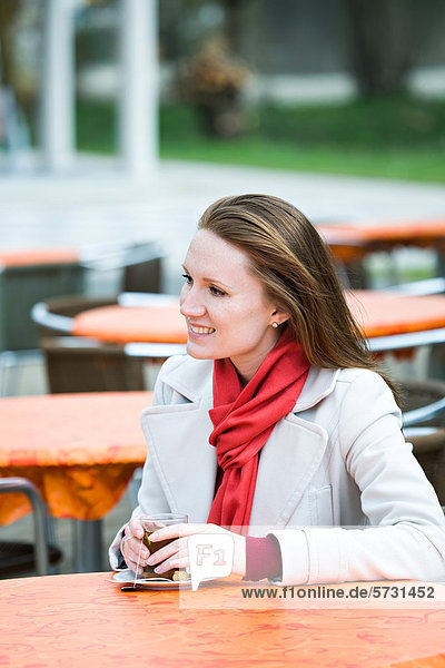 Young woman in an outdoor cafe
