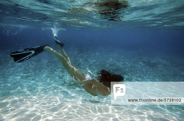 Woman snorkeling in Maldives  underwater view                                                                                                                                                       