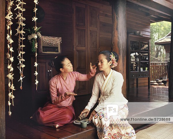 Aia  Thailand  woman applying Thanaka cosmetic in face                                                                                                                                              