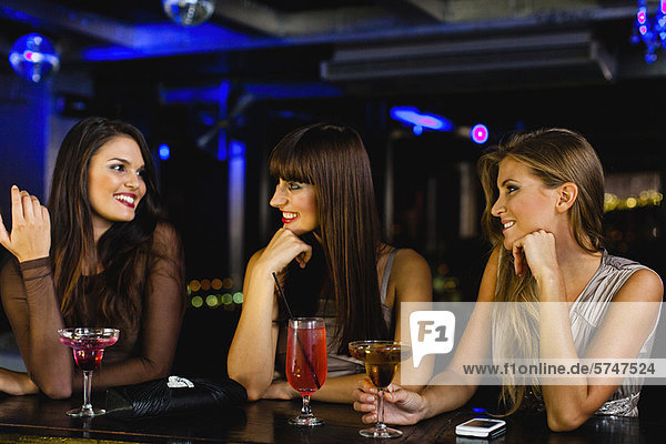Women having drinks together at bar