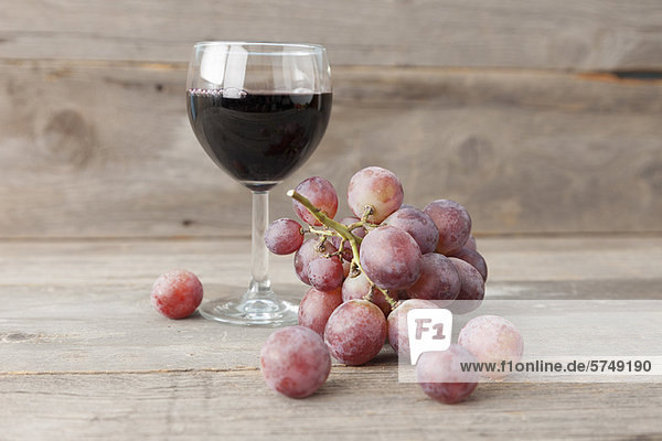 Close up of grapes and glass of wine