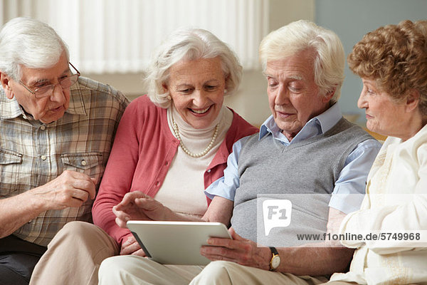 Senior adults using digital tablet