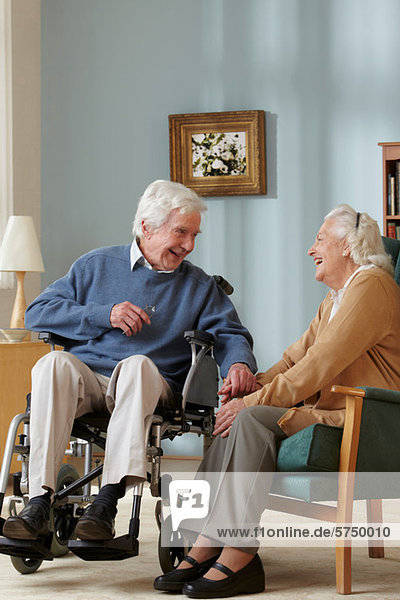 Senior couple in care home  man in wheelchair