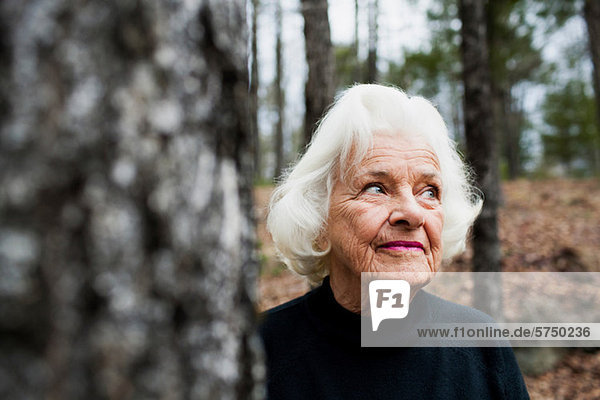 Portrait of senior Woman looking away in Wald