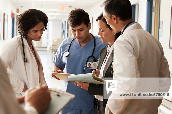 Doctors discussing patients charts in hospital