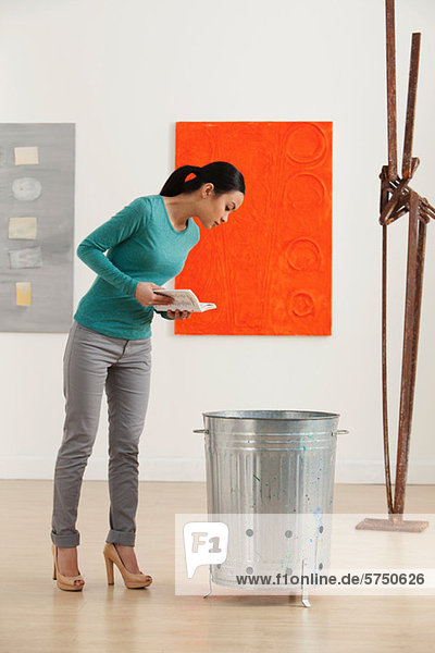 Young woman looking at artwork in gallery