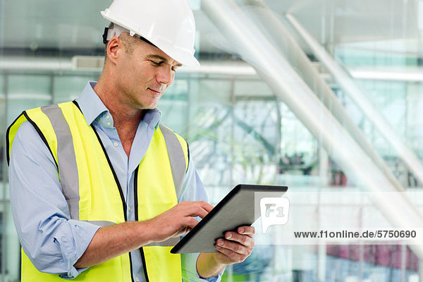 Engineer using digital tablet in office