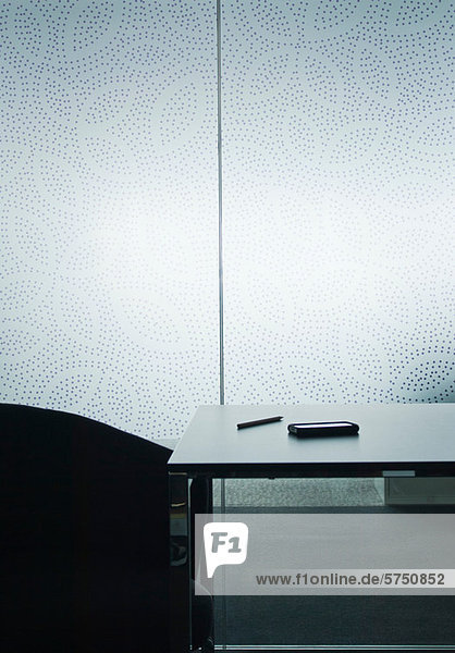 Smartphone on table in empty room