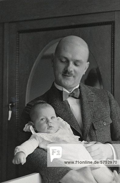 Historical picture of a father with a baby