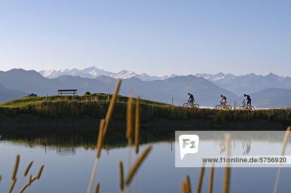 Mountain bikers at Salvensee Lake  Mt Hohe Salve  Mt Kitzbueheler Horn  Kitzbuehel Alps  Tyrol  Austria  Europe