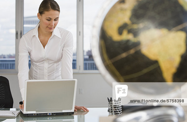 Businesswoman looking at laptop