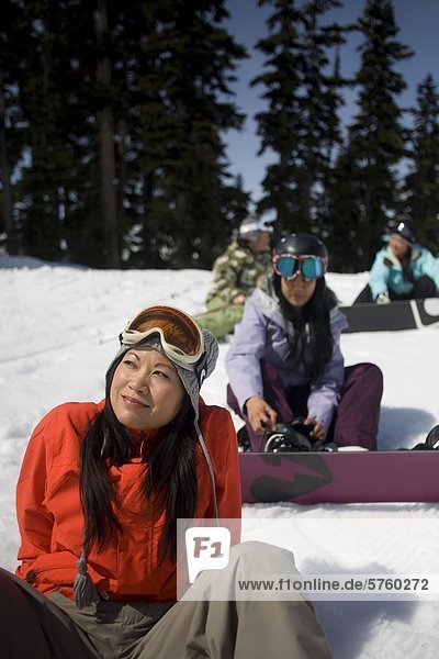 Young asian female skiers and snowboarders  Whistler Mountain  British Columbia  Canada.