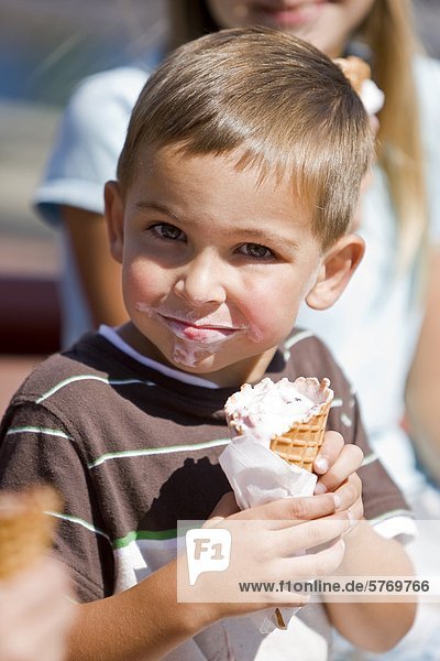 A young boy  his faced covered in ice cream  poses for an informal portrait while visiting the Nanaimo waterfront shops and stores  Nanaimo  Central Vancouver Island  British Columbia  Canada.