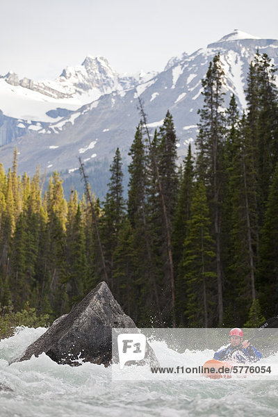 A man enjoying the whitewater of the Mystia River  Banff National Park  Alberta  Canada