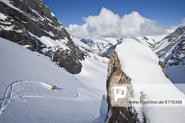 A male backcountry skier finds fresh powder while on a hut trip at Icefall Lodge  Golden  British Columbia  Canada