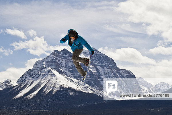 Young man snowboarding at Lake Louise Resort  Banff National Park  Alberta  Canada.
