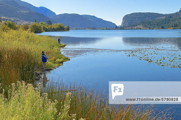Man and woman fish at Vaseux Lake  Okanagan Region  British Columbia  Canada