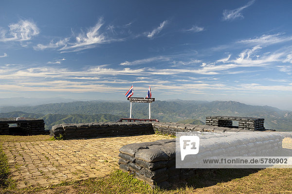 Border between Thailand and Burma or Myanmar Thai national flags and a sign northern Thailand Thailand Asia