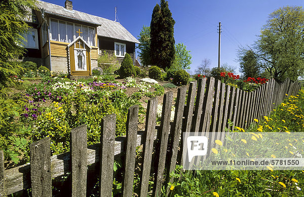 Wooden house  fence  garden  village  Lithuania  Europe