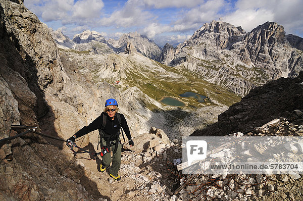 Teenager climbing on the Paternkofel fixed rope route  Boedenseen lakes  Hochpustertal valley  Dolomites  Province of Bolzano-Bozen  Italy  Europe