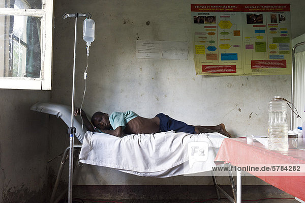 Patient with an intravenous drip tubing attached in poorly equipped clinic  Quelimane Mozambique  Africa