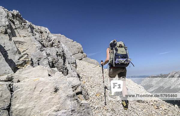 Hiker carrying a backpack  Karwendel nature park  Tyrol  Austria  Europe