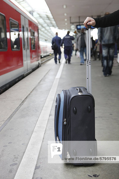 A suitcase and a hand  platform  railway station  Cologne  North Rhine-Westphalia  Germany  Europe
