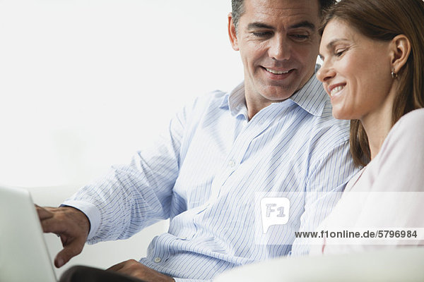 Couple looking at laptop computer together