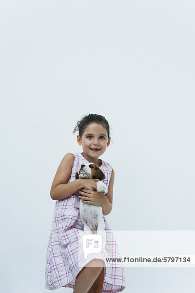 Girl holding beagle puppy