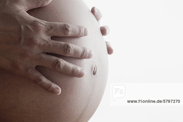 Schwangere Frau  die den Bauch berührt  abgeschnitten