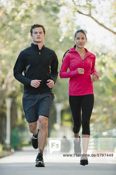 Young couple jogging side by side