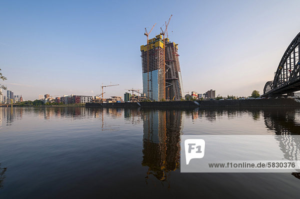Building site of the European Central Bank  ECB  at sunrise on the site of the former wholesale market halls with construction cranes  Deutschherrnbruecke bridge at front  right  Frankfurt am Main  Hesse  Germany  Europe  PublicGround
