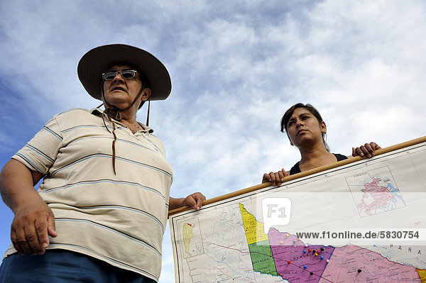 Environmental activists with a map of the floodplains of the Pilcomayo river  the area is being destroyed by a project supported by the Inter-American Development Bank  IDB  preventing on the one side the drainage of water  on the other it leads to the marshes drying up  Banado la Estrella  Formosa Province  Argentina  South America