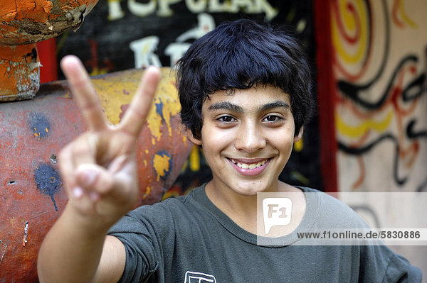'Young person making the ''victory'' sign  Buenos Aires  Argentina  South America'