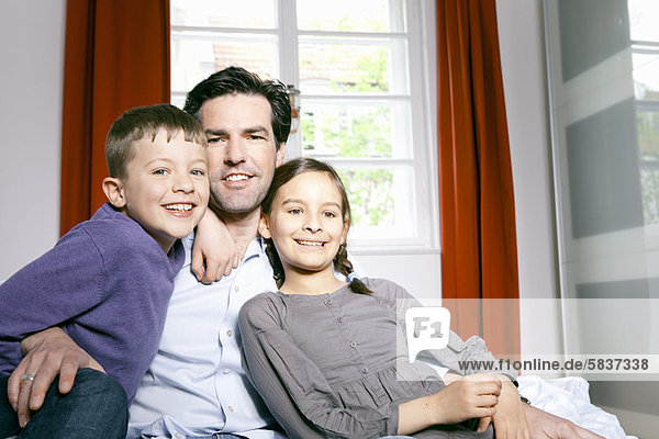 Father and children smiling together