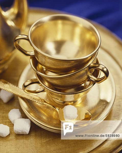'Gold Tea Cups  Saucers and Spoon
