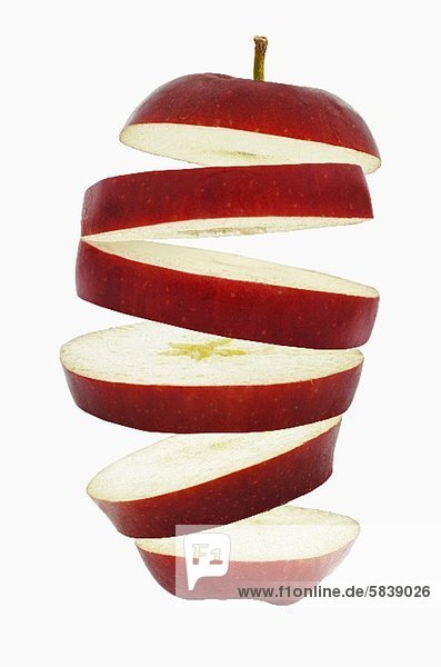 Flying slices of red apple